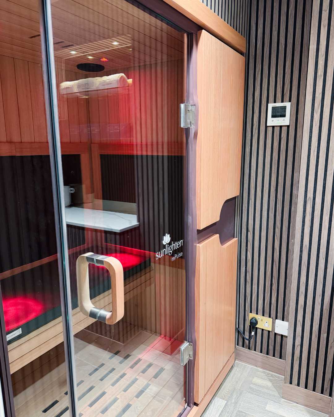 Infrared sauna located at Luminis Chislehurst, a modern wellness and beauty salon.