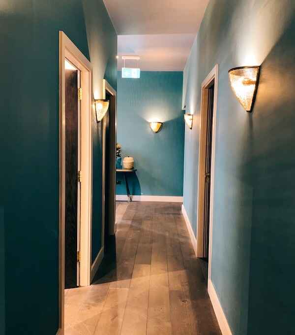 An ambient, dim lit, beauty salon hallway in Luminis Chiswick.