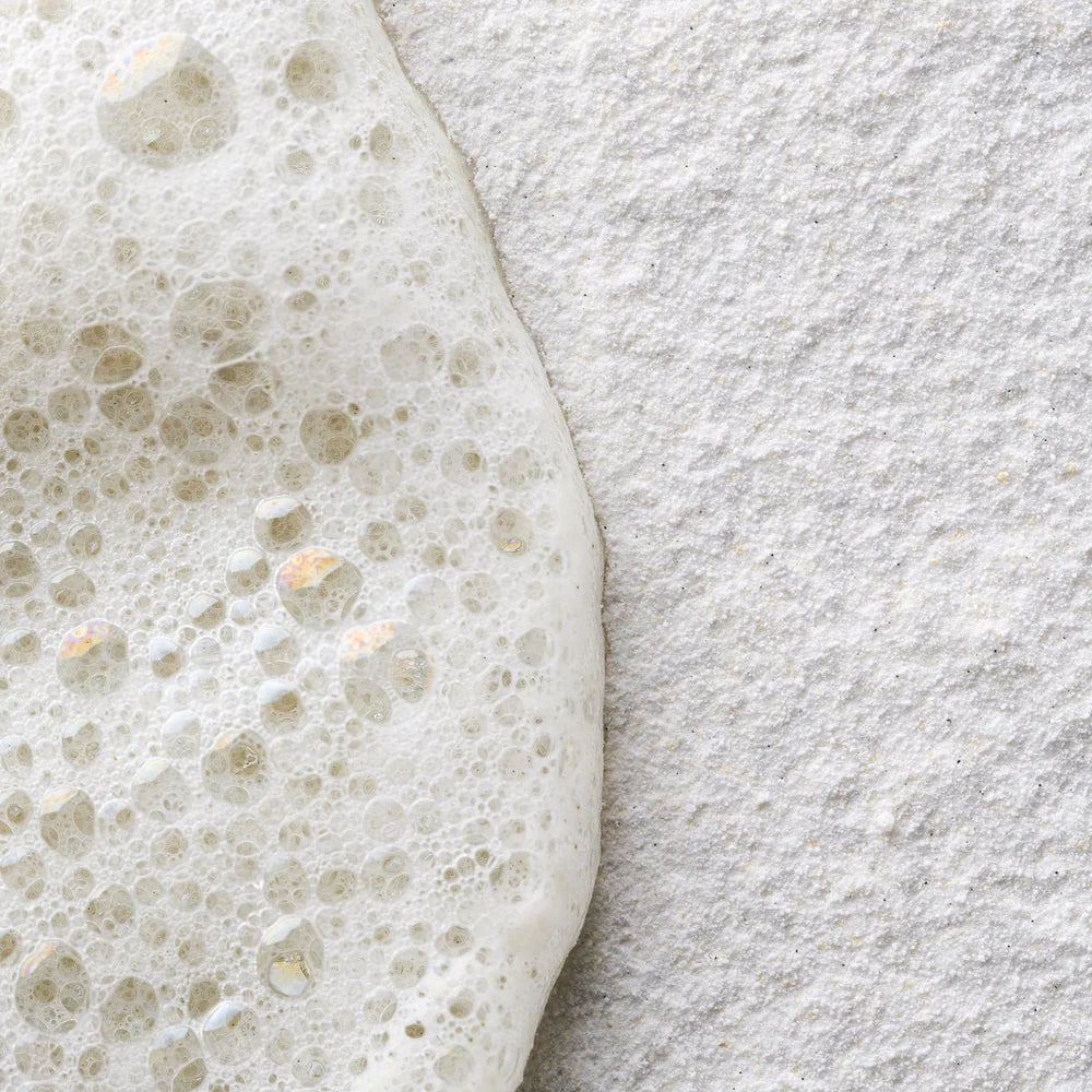 Close-up of a textured gray surface with a white foam-like substance on top