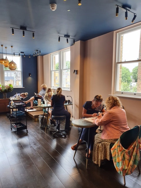 Luminis Chiswick's manicure and pedicure stations that have therapists performing manicures and pedicures on Luminis clients.