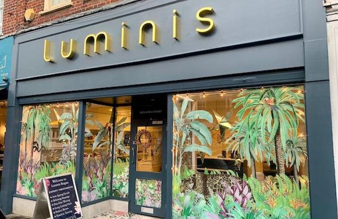 Luminis Beauty Salon Reigate exterior image featuring jungle themed vinyls on the salon front windows.