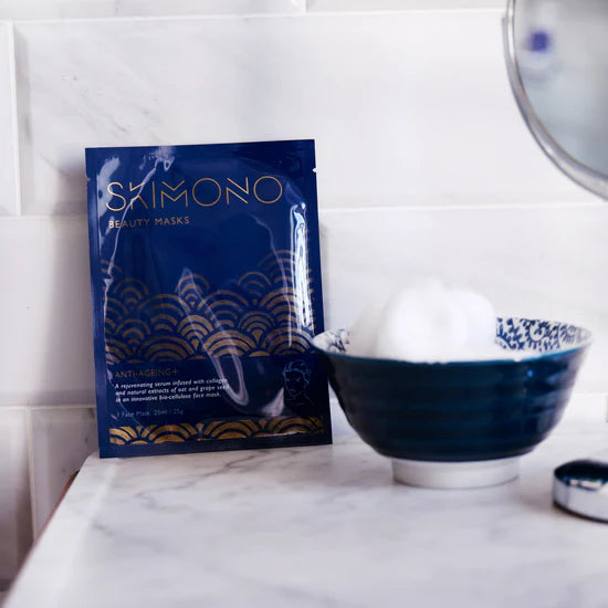 The Skimono Anti Ageing Face Mask in the bathroom, accompanied by a navy bowl with cotton pads in it.