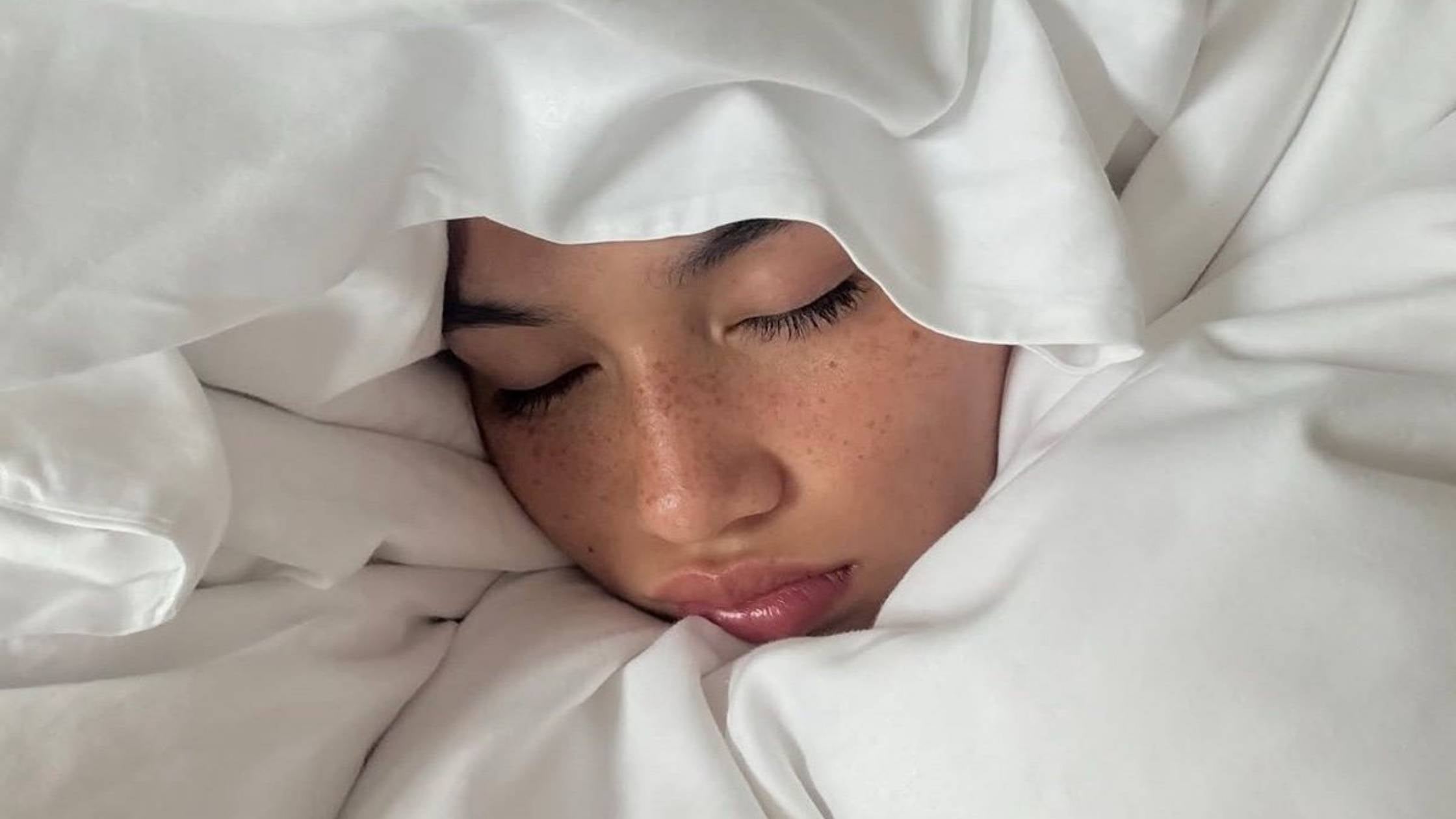 Lady snuggled up in bed