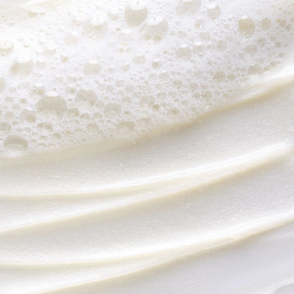 Close-up of white cream with bubbles on a white background