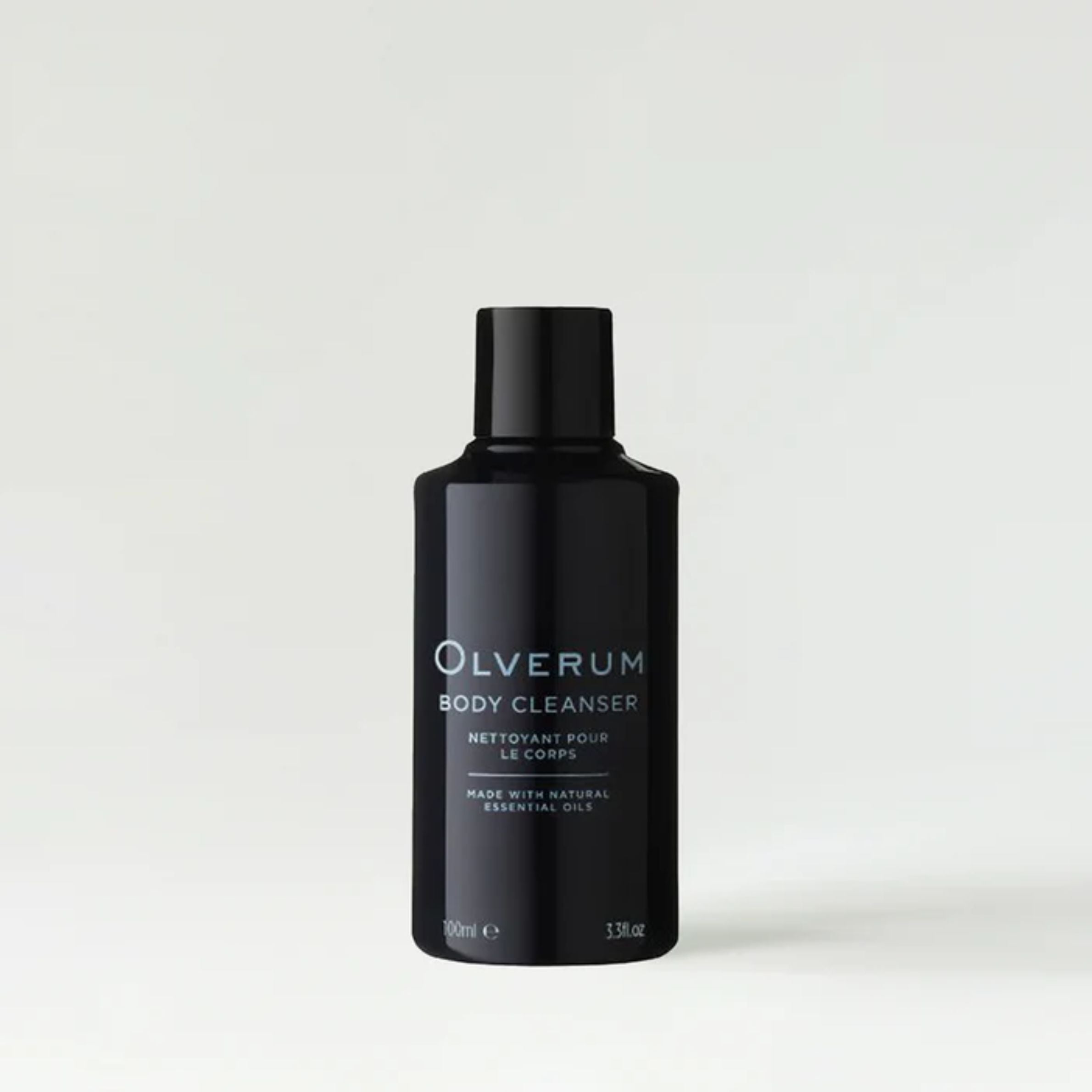 Black bottle of Olverum body cleanser on a white background