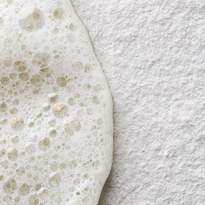 Close-up of a textured gray surface with a white foam-like substance on top