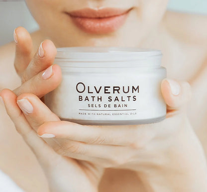 A close up of a woman holding Olverum&
