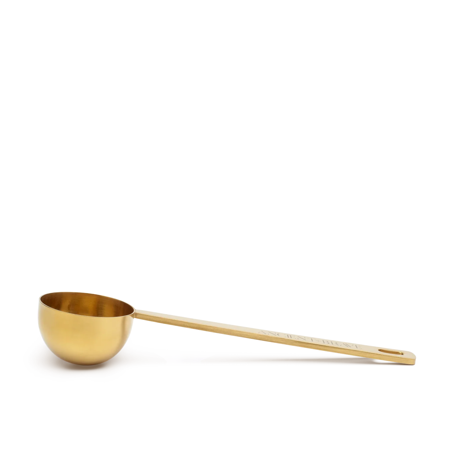 Gold measuring spoon on a white background