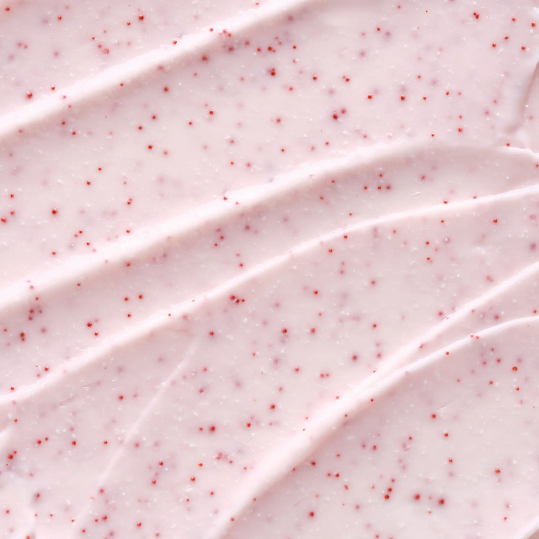 Close-up of pink whipped cream with red specks