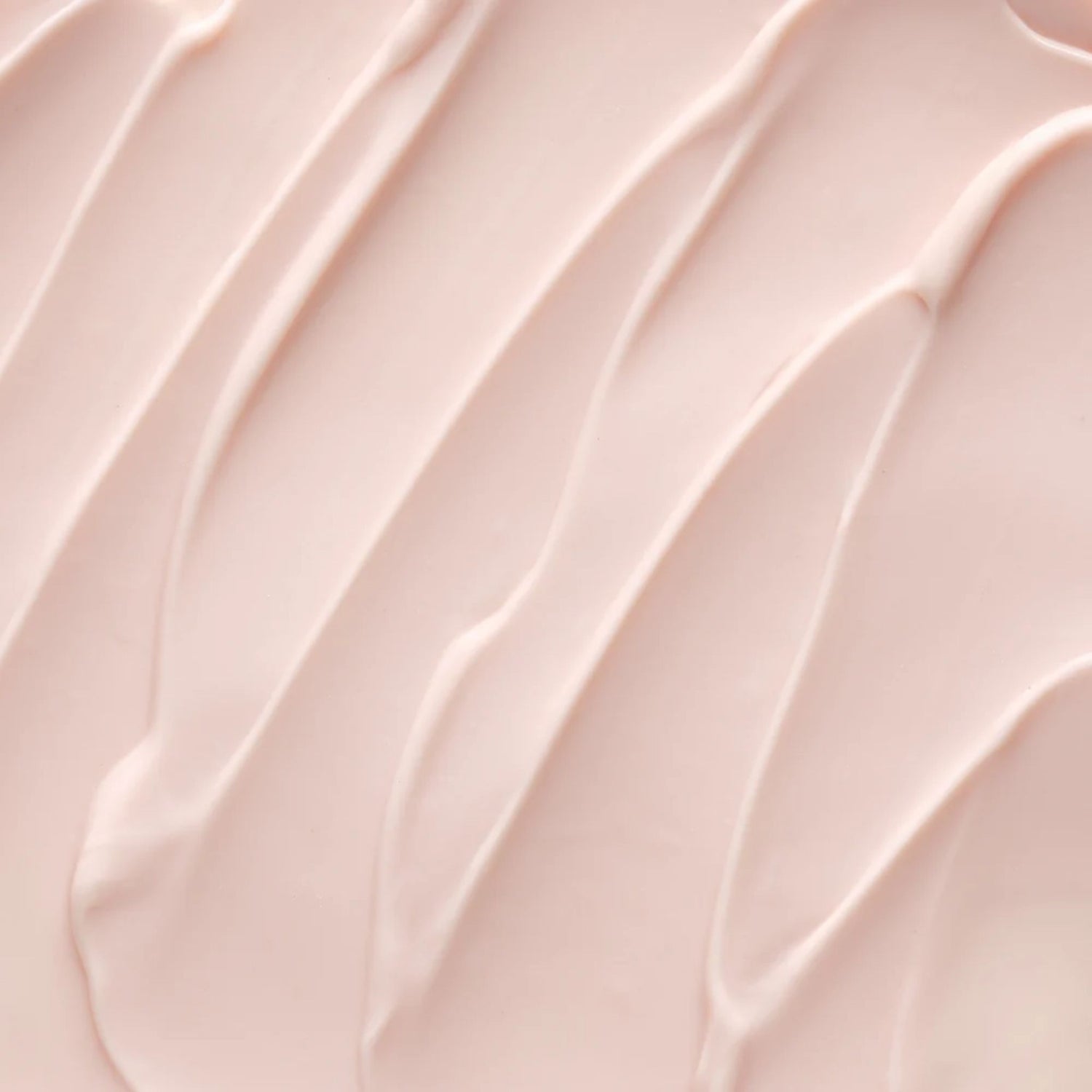 A close-up texture shot of a smooth, pale pink cream or lotion swatch with elegant diagonal swirled lines.