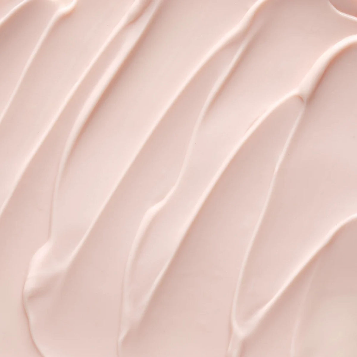 A close-up texture shot of a smooth, pale pink cream or lotion swatch with elegant diagonal swirled lines.